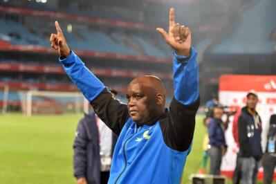 Soccer coach Pitso Mosimane holds up his hands in celebration