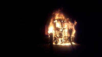 A vehicle on fire at night