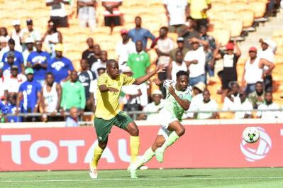 Bafana Bafana player Hlompho Kekana battles for the ball with Nigeria player Ahmed Musa