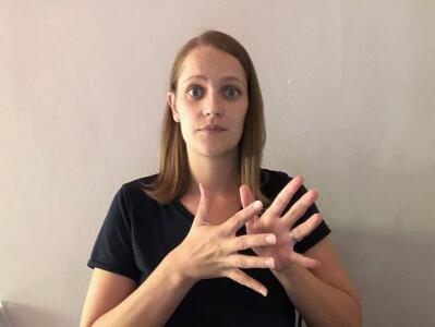 A woman uses sign language.