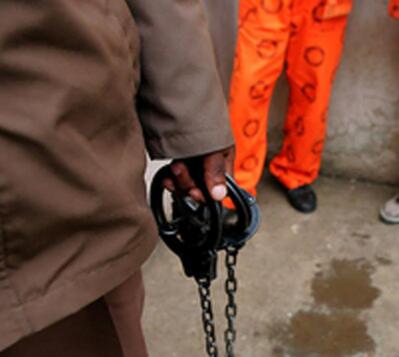 Prisoner in orange suit.