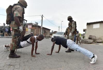 Two soldiers and two civilians doing push-ups
