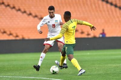 Bafana Bafana player Lebohang Maboe battles for the ball with Seychelles player Karl Hopprich