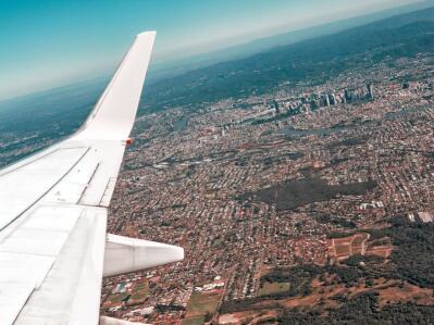 Aerial view over the wing of an aeroplane.