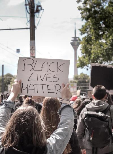 A protester holding a placard written Black Lives Matter