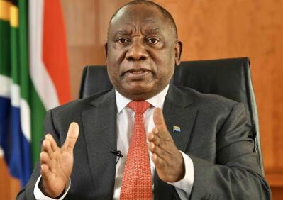 Ramaphosa using hand gestures while sitting on an armchair