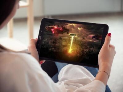 A woman watches a movie on her tablet computer.