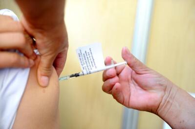 Health worker administers Covid-19 vaccine