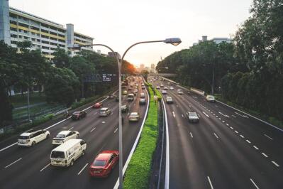 Cars drive on a highway.