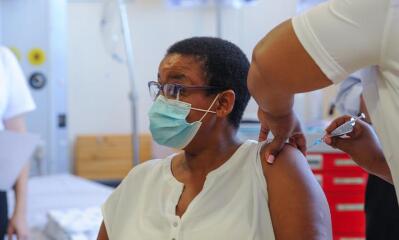 Nurse injects vaccine into patient’s arm.