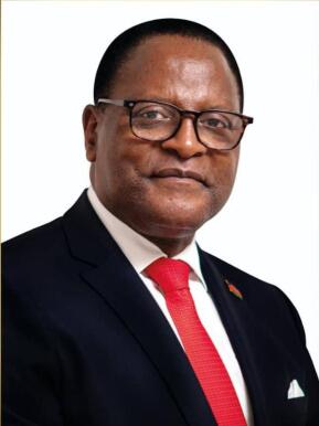 Malawi President Lazarus Chakwera wears a suit and red tie.