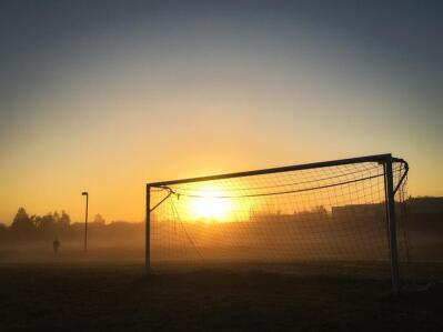 Soccer goalposts at sunrise