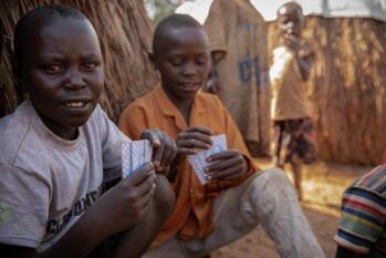 Displaced children playing cards in IDP centre in DRC.
