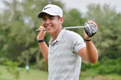 Young golfer Garrick Higgo poses with his golf club behind his shoulders