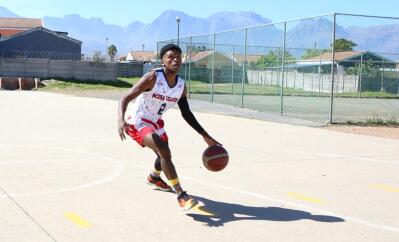 A young basketball player dribbles the ball
