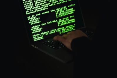 A man writing code on a computer. 