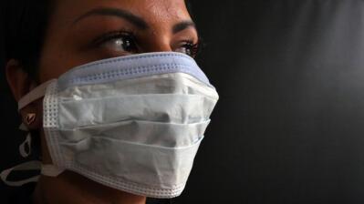 A woman wears a face mask to protect against Covid-19.