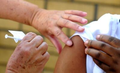 Health workers administering Covid-19 vaccine.