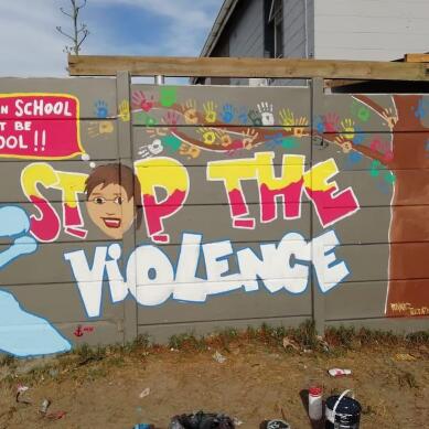 Wall mural saying stop the violence.