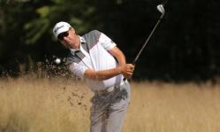 Golfer Jake Roos plays a shot out of a bunker