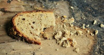 Close up of broken bread and crumbs that can be used to illustrate hunger or famine 