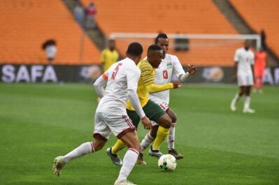 Bafana Bafana player Lebohang Maboe battles for the ball with Seychelles players Jones Joubert Colin Esther during the Africa Cup Of Nations qualifiers at FNB stadium