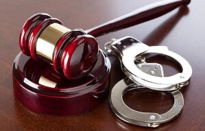 An image of handcuffs and a judge’s gavel
