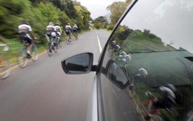 Cyclists ride on a road.