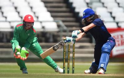 two women’s cricketers in action
