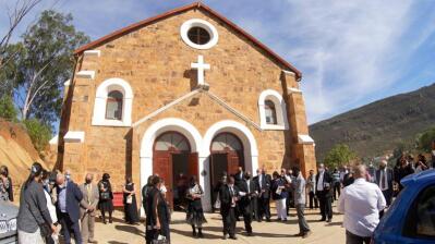 People gather around a church.