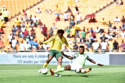 Bafana Bafana player Percy Tau battle for the ball with Nigeria player Ojim Kalu battle for the ball
